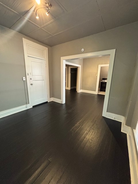 A room with a white door and a white wall.