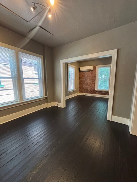A room with wooden floors and a window.