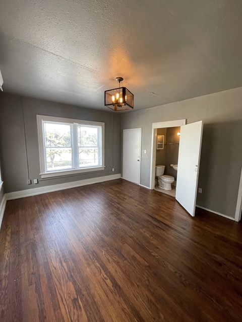 A room with wooden floors and a window.