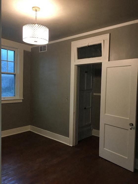 a empty room with a door and a light