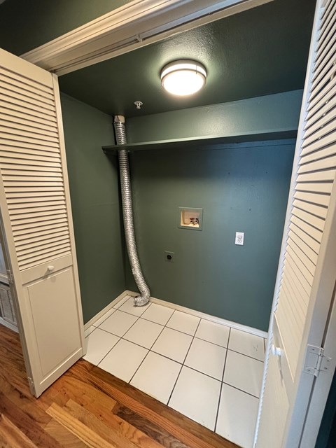 A bathroom with a green wall and a white door.