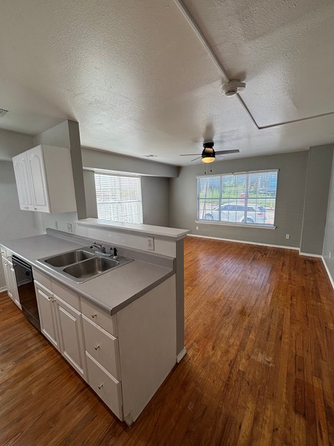 A kitchen with wooden floors and a window.