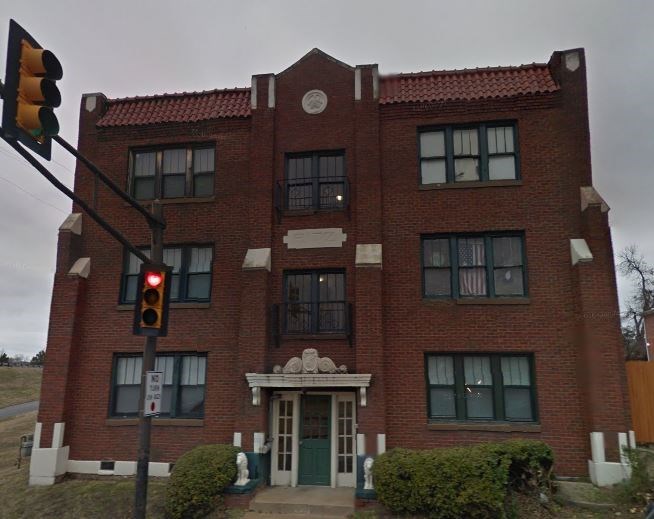 a red brick building with a traffic light