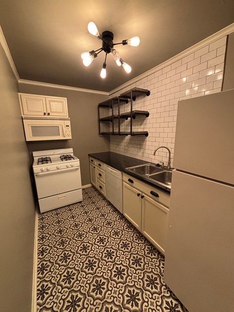 A small kitchen with a black and white patterned floor.