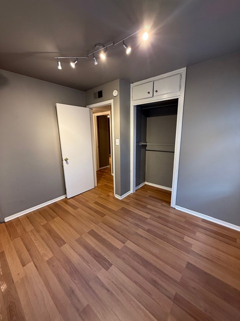 A room with a wooden floor and a white door.