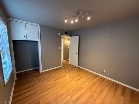 A room with wooden floors and a white door.