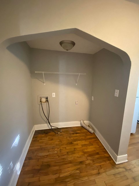 the living room is being remodeled with wood floors and a ceiling fan