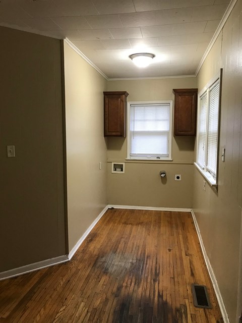a living room with wood floors and a window