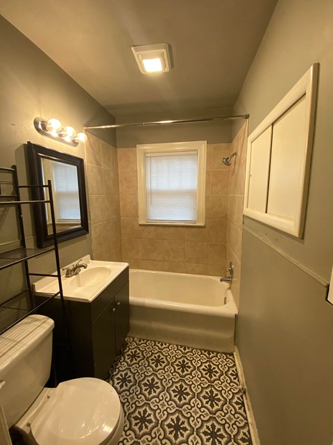 a bathroom with a toilet and a sink and a bath tub