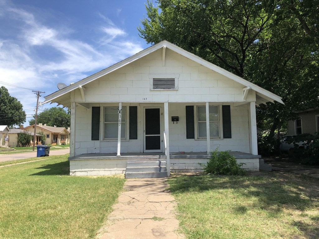 a small white house with a front porch