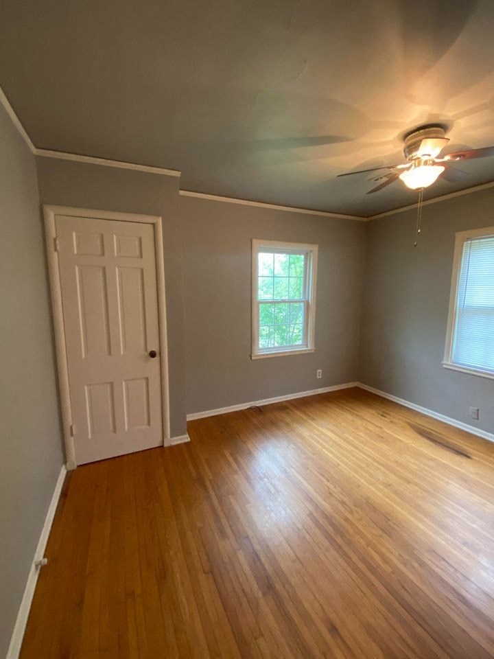 a living room with a wooden floor and a white door