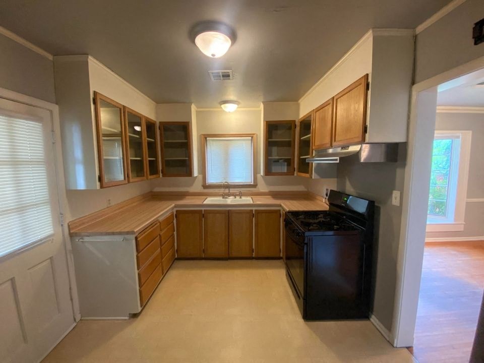 a kitchen with a black stove and a sink