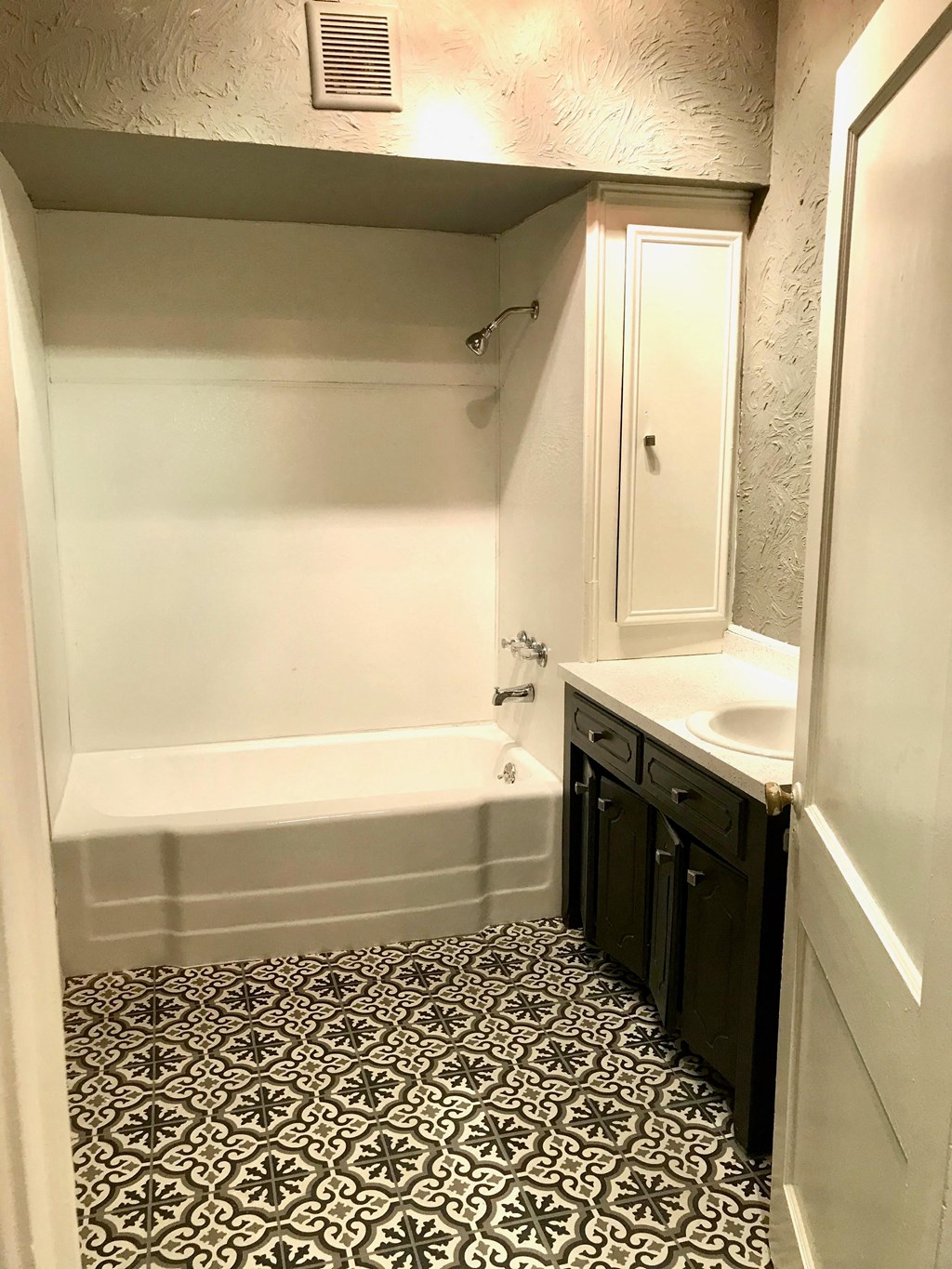 a small bathroom with a sink and a bath tub