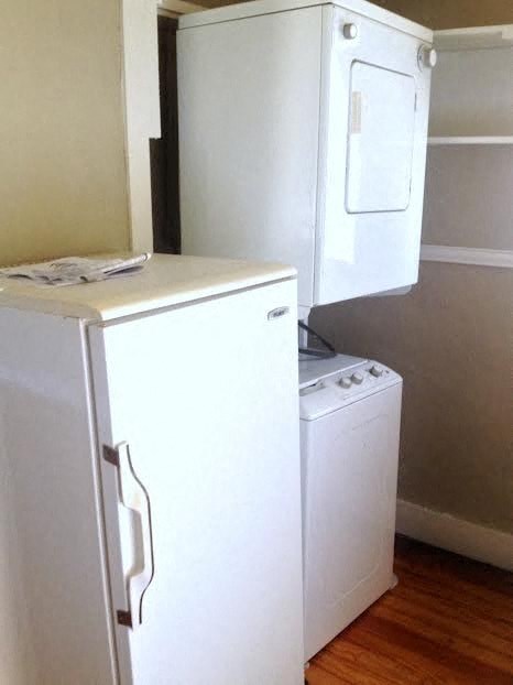 a small kitchen with a refrigerator and a washing machine