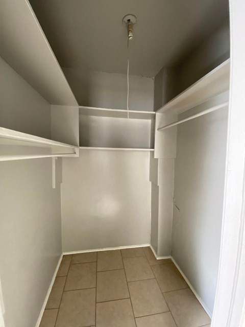 a room with white walls and a ceiling and a tiled floor