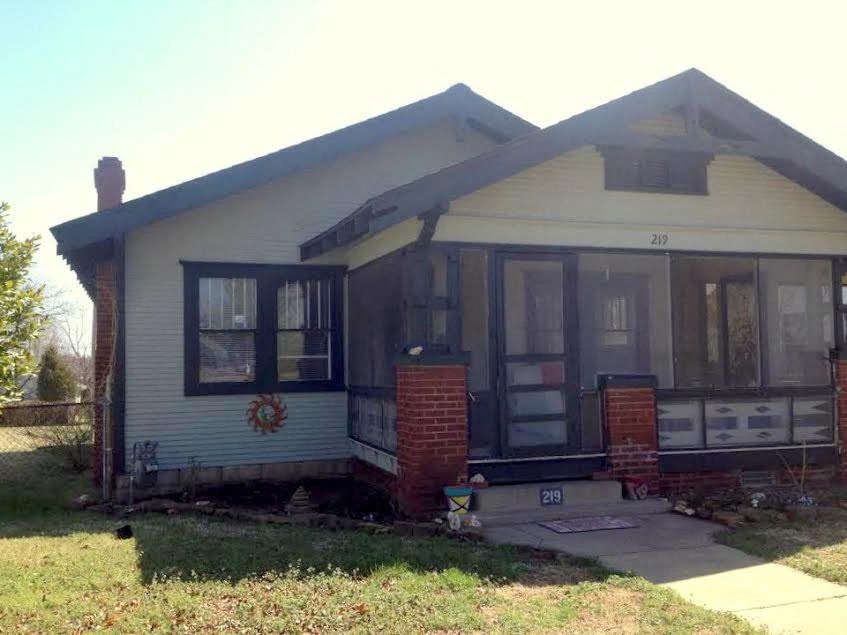A house with the number 210 on the front door.