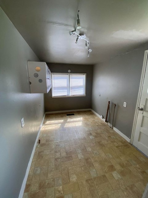 A room with a tiled floor and a window.