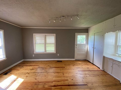A room with wooden floors and white walls.