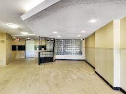 a large empty room with a white floor and white walls