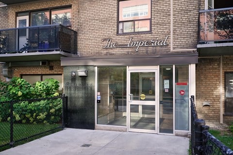 The Imperial building has a black fence in front of it.