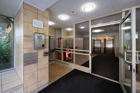 The image shows a hallway with a sign that reads "Myriad".