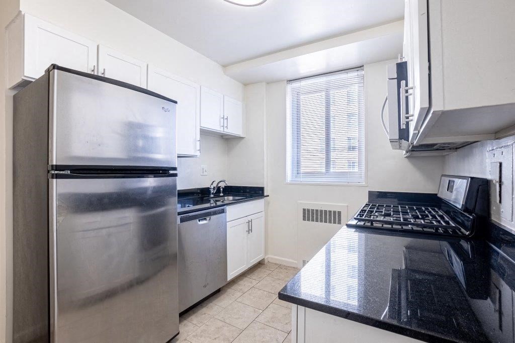 a kitchen with stainless steel appliances and black counter tops
