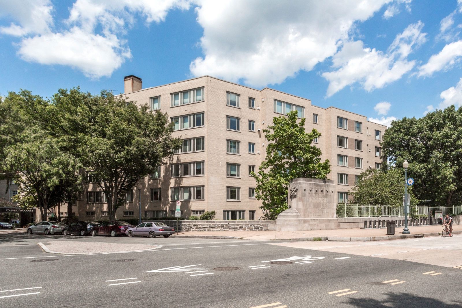 a large building with a statue in front of it on a city street