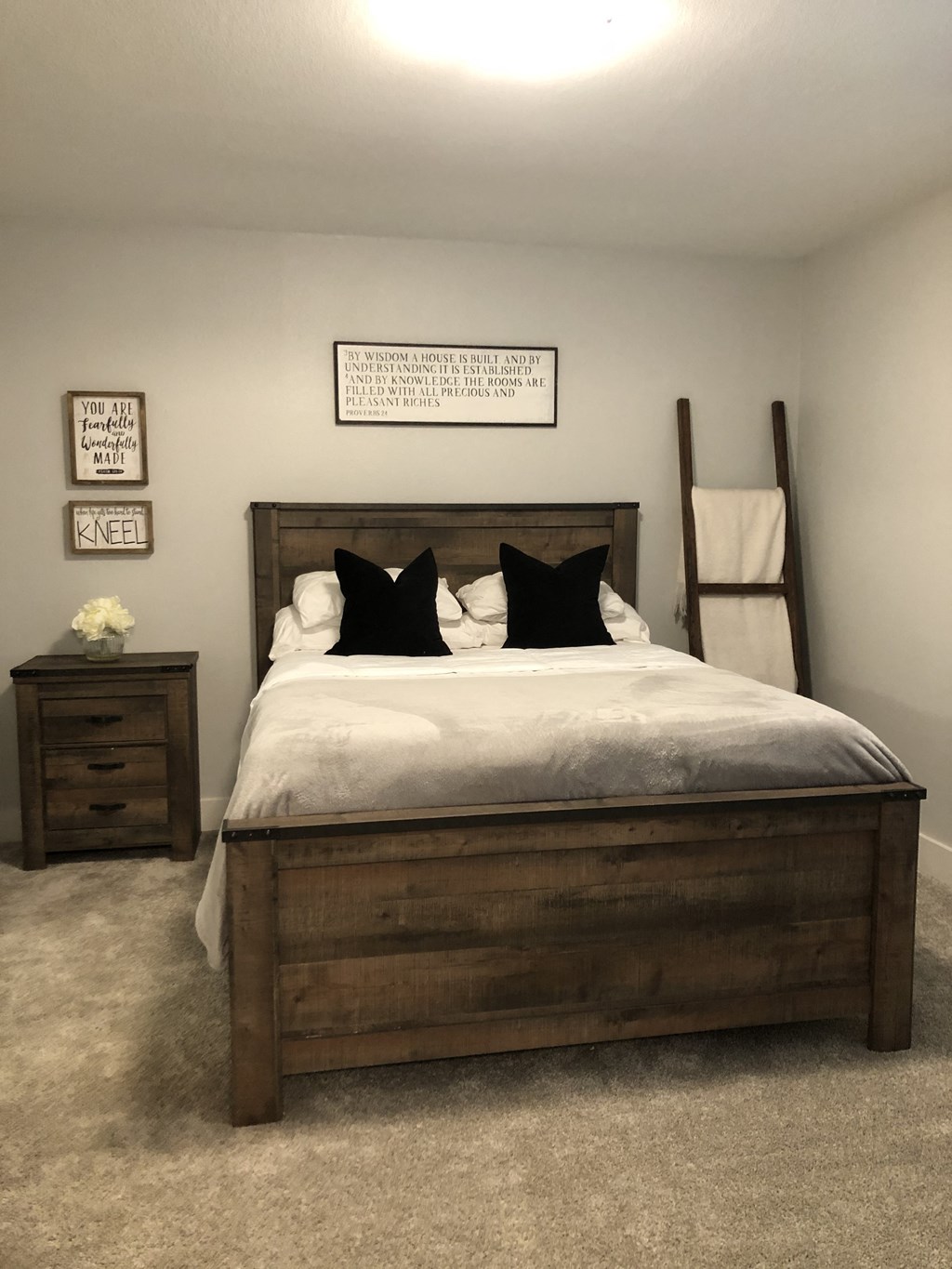 a bedroom with a bed and some pictures on the wall