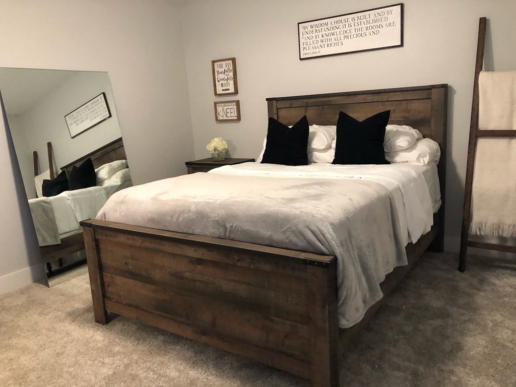 a bedroom with a bed and a mirror