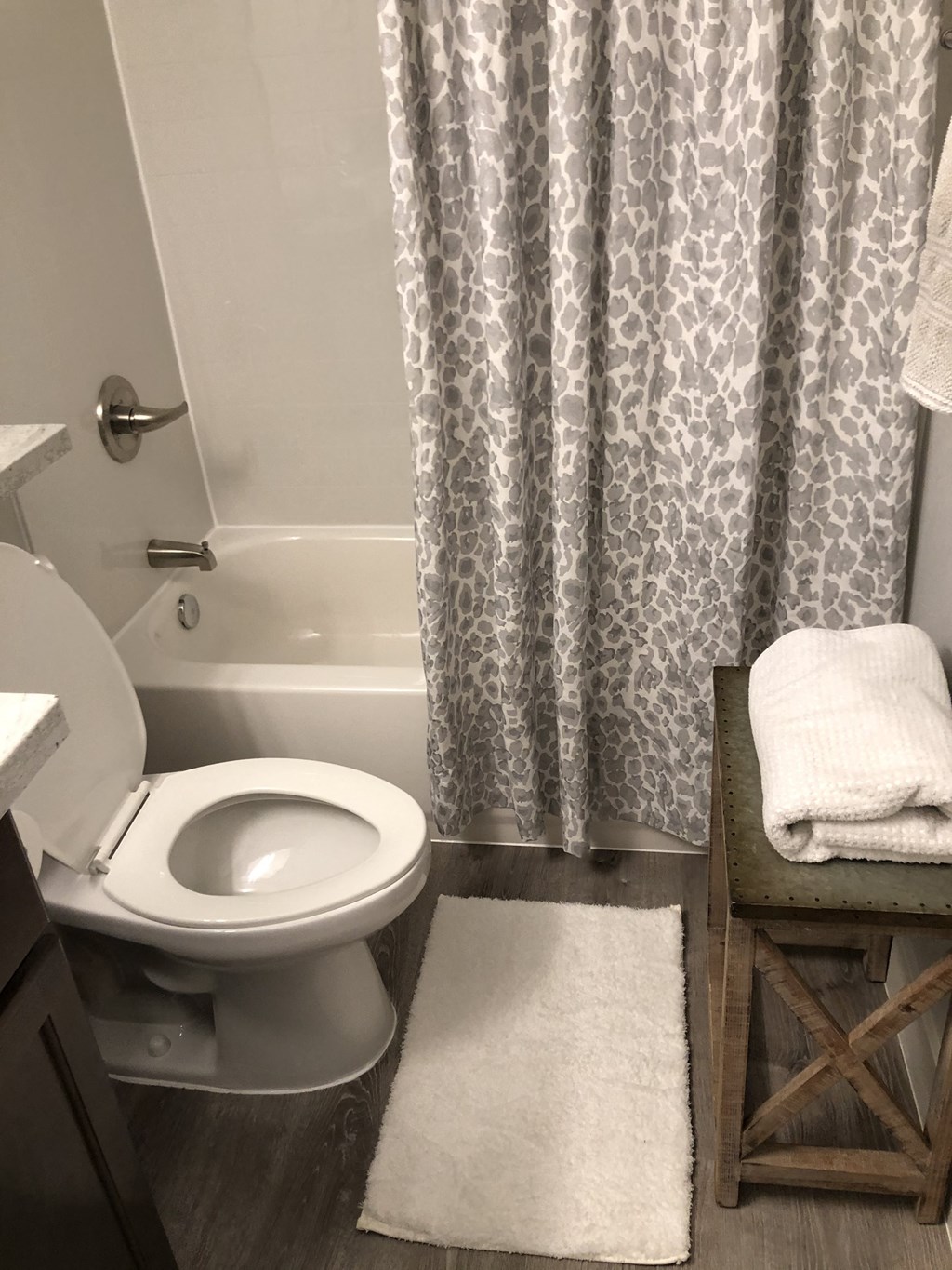 a bathroom with a toilet and a tub and a shower curtain