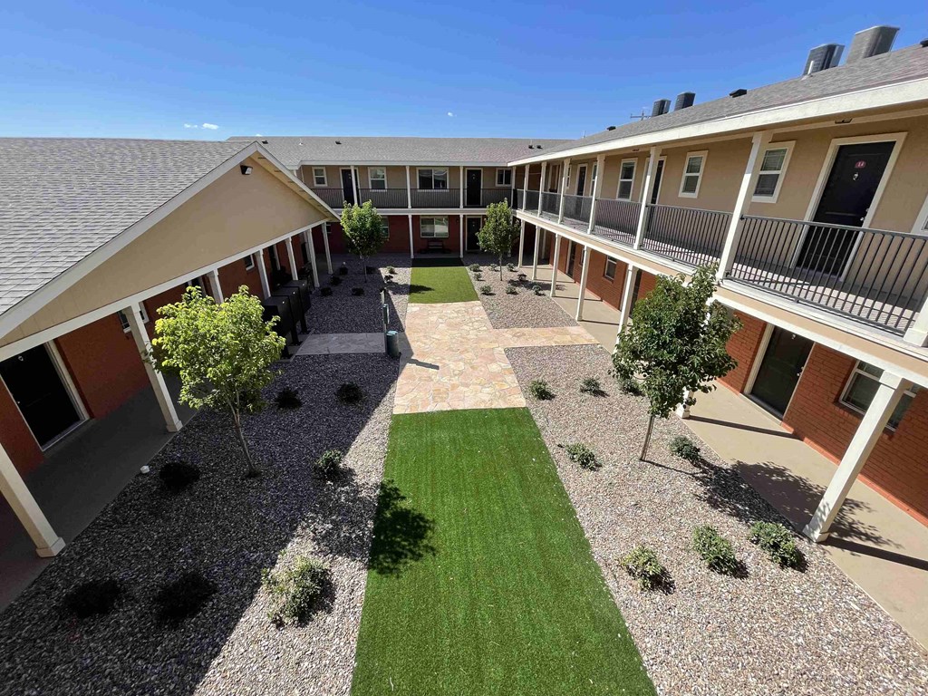 an aerial view of the courtyard of an apartment building