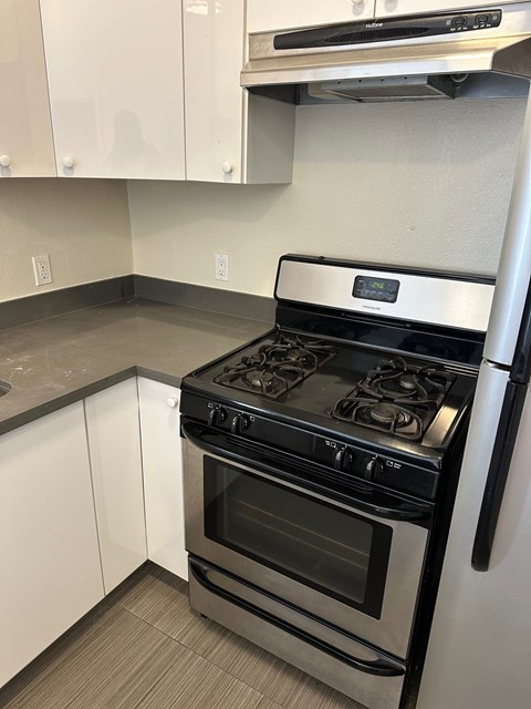 A modern kitchen with a stove and oven.