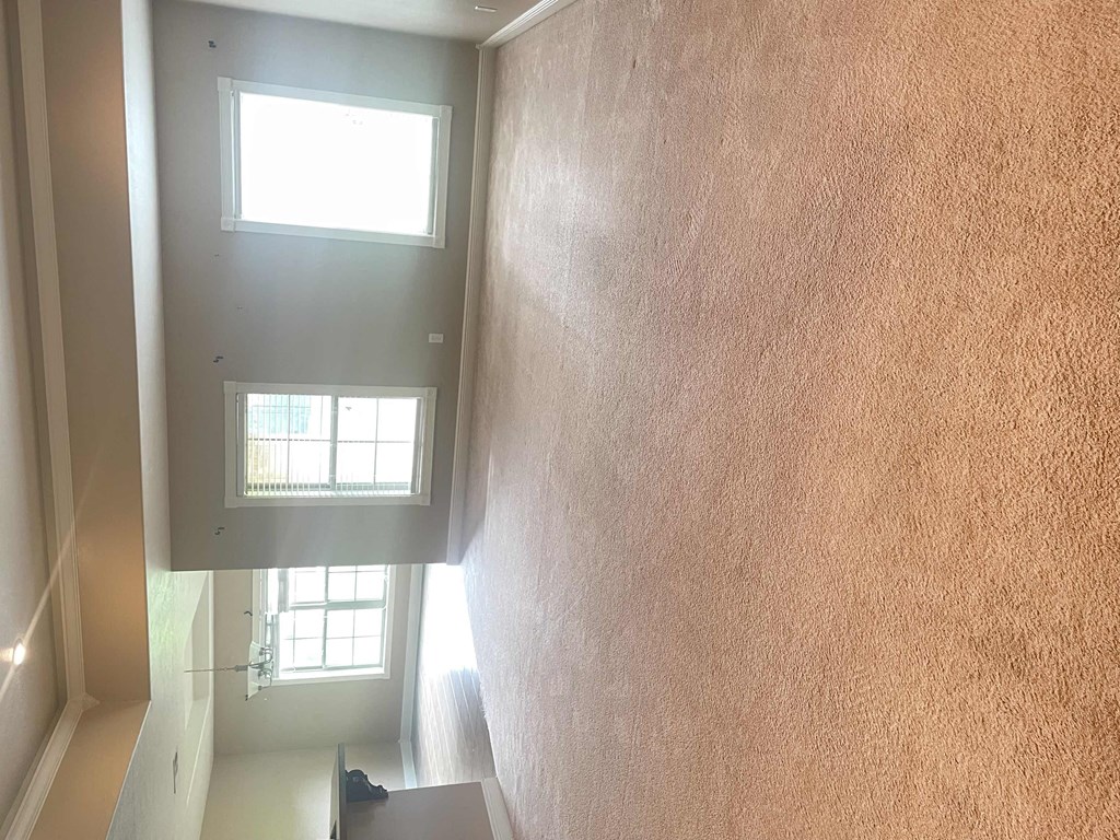 a view of the hallway from the top of the house looking down at the stairs