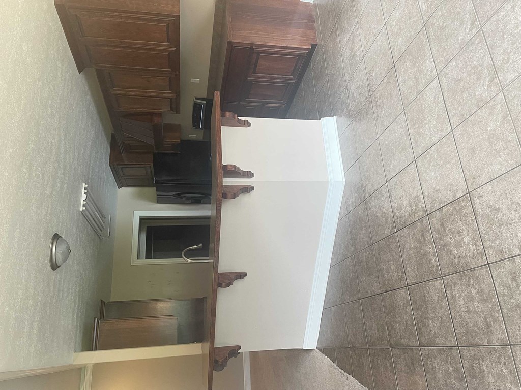 a view of the kitchen from the top of the stairs