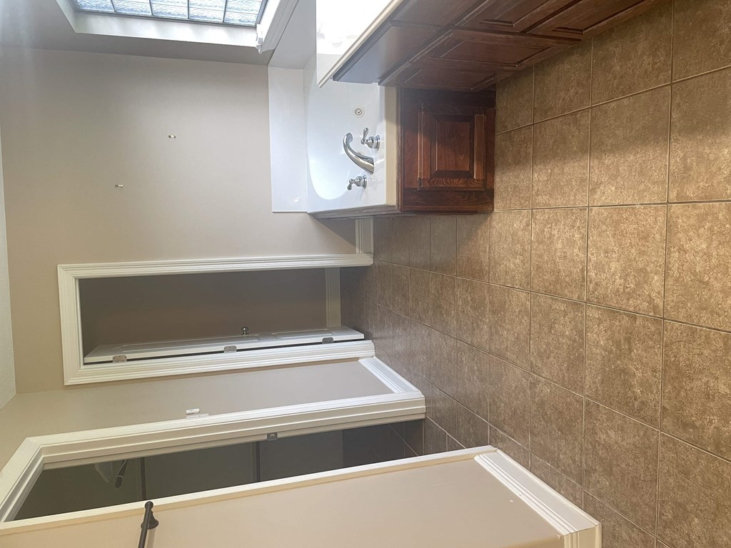 a bathroom with a tub and a sink and a window