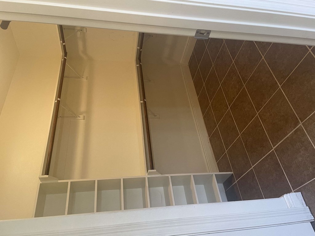 the closet in the master bathroom has a mirror on the wall