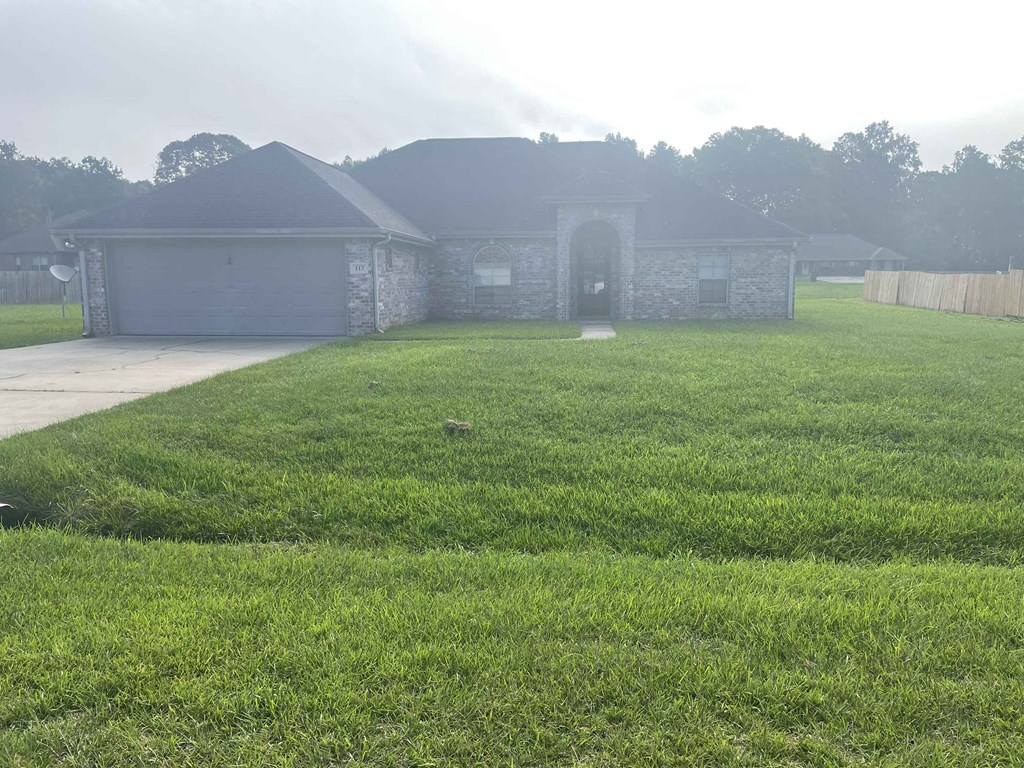 a yard in front of a house with grass