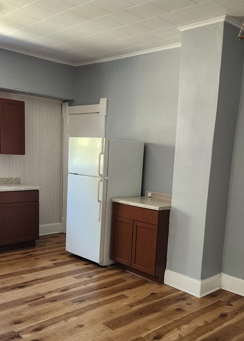 a small kitchen with a refrigerator and a sink