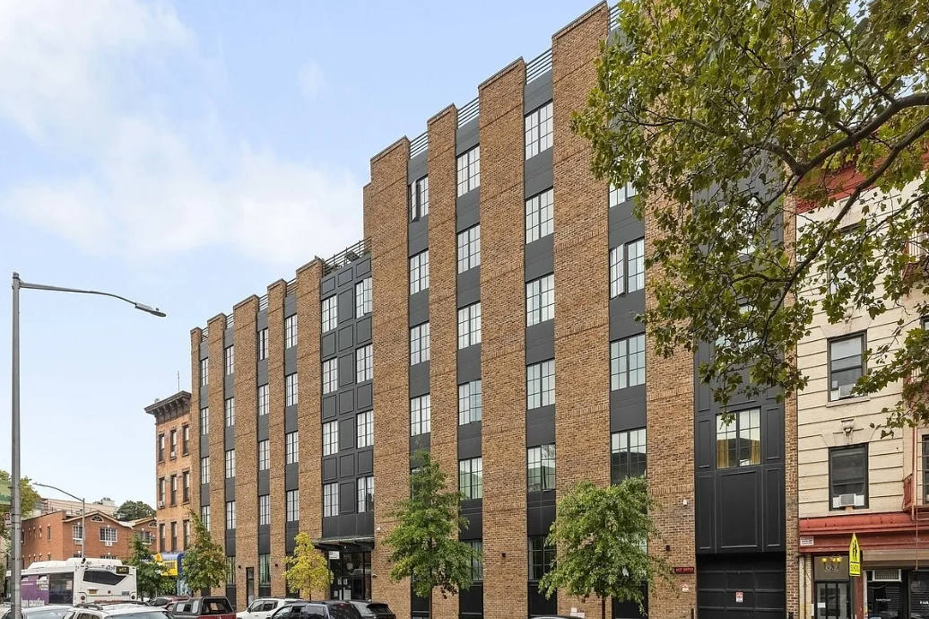 an apartment building on the corner of a city street