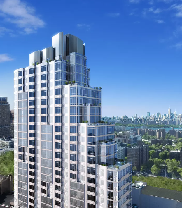 an aerial view of a tall skyscraper with a city in the background