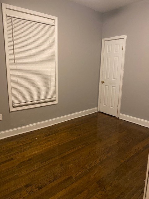 an empty room with a window and a door