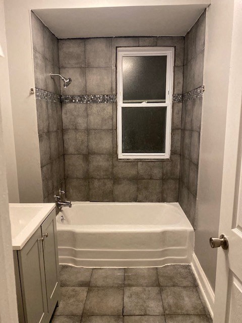 a small bathroom with a tub and a window