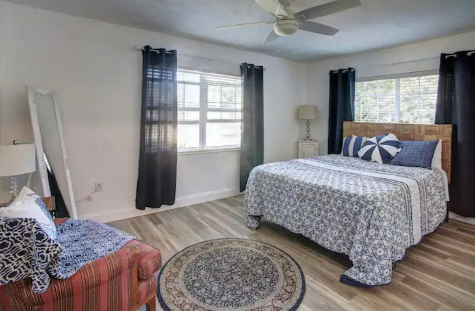a bedroom with a bed and a ceiling fan