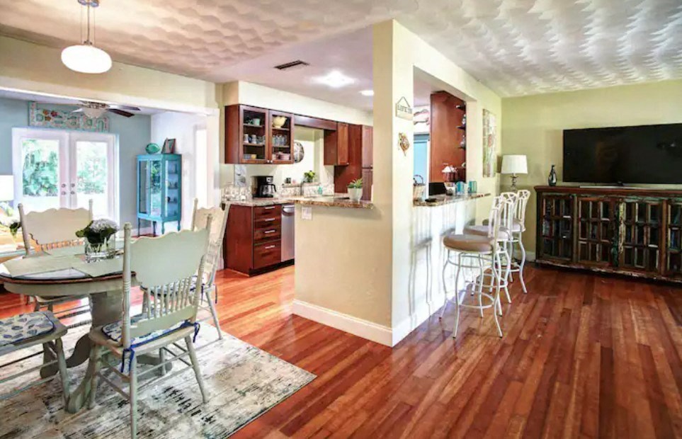 a kitchen and dining room with a table and chairs