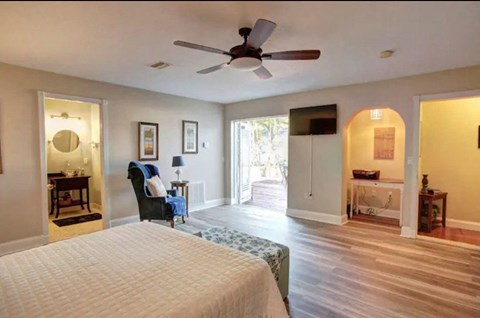 a bedroom with a large bed and a ceiling fan