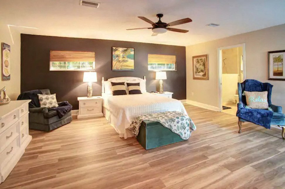 a bedroom with a bed and a ceiling fan