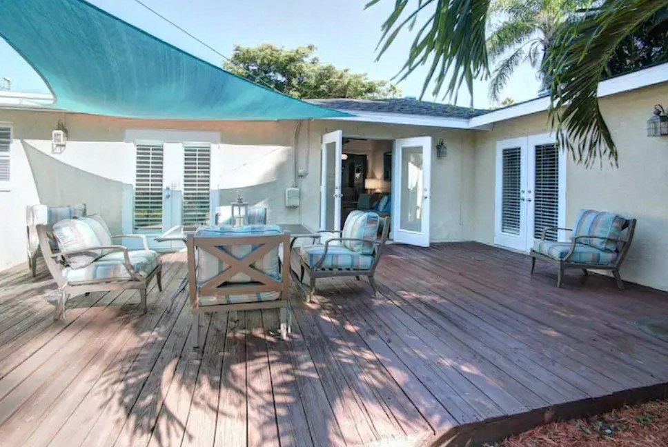 a patio with a table and chairs on a deck