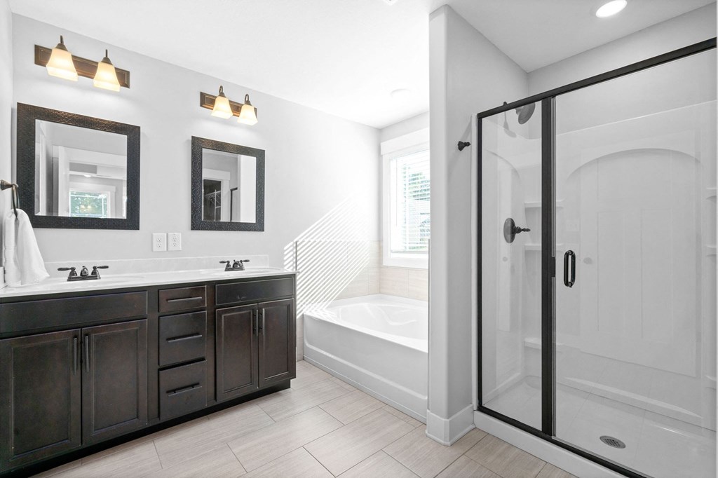 a bathroom with a shower and a sink and a bath tub