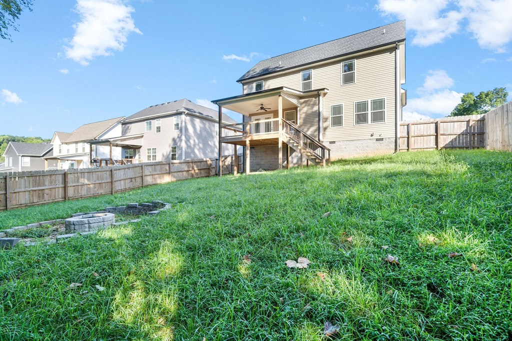 the back yard of a house with a backyard and a fence