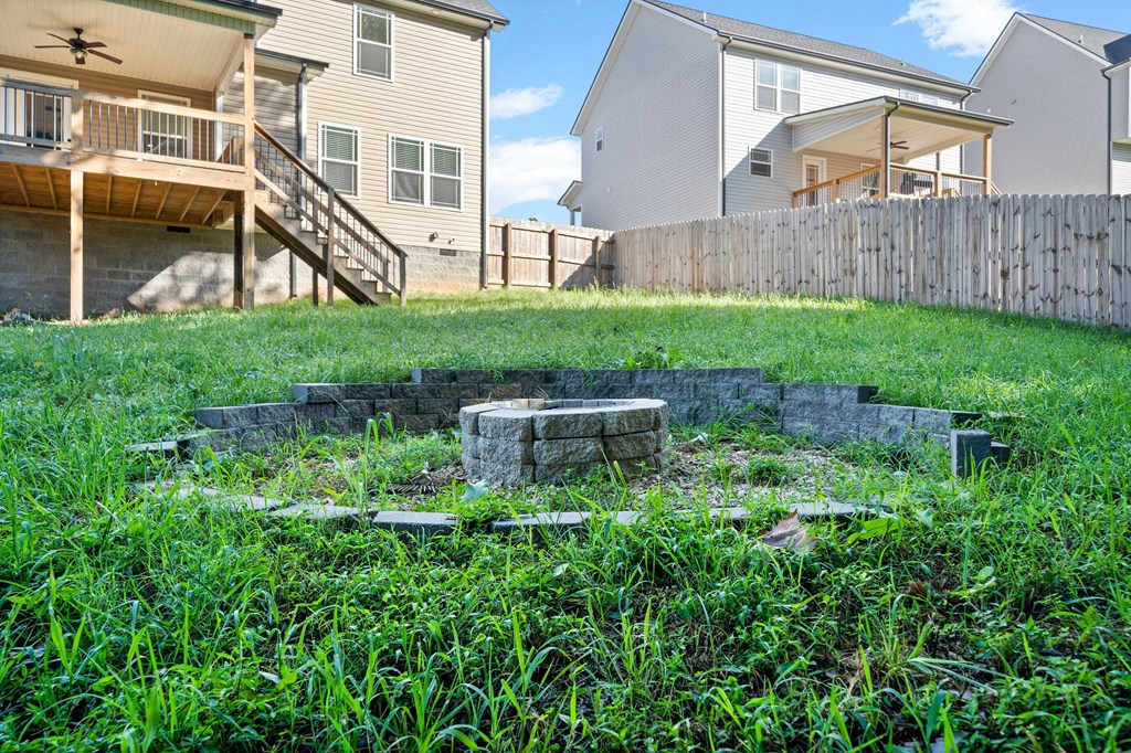 a retaining wall in the grass in front of houses